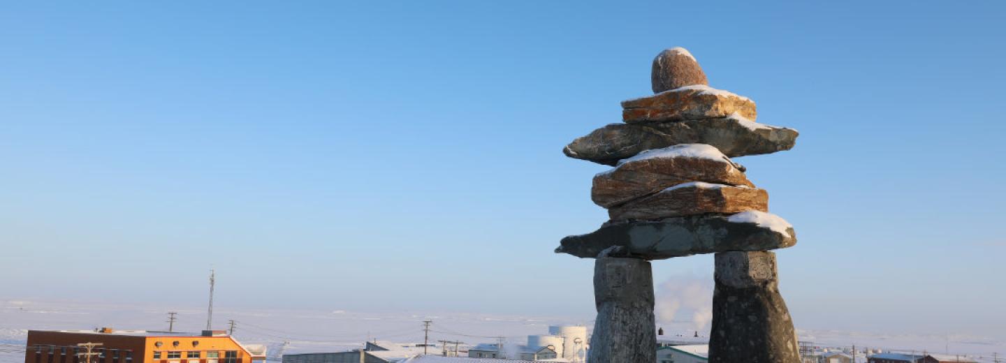 A landscape photo of an Inuksuk